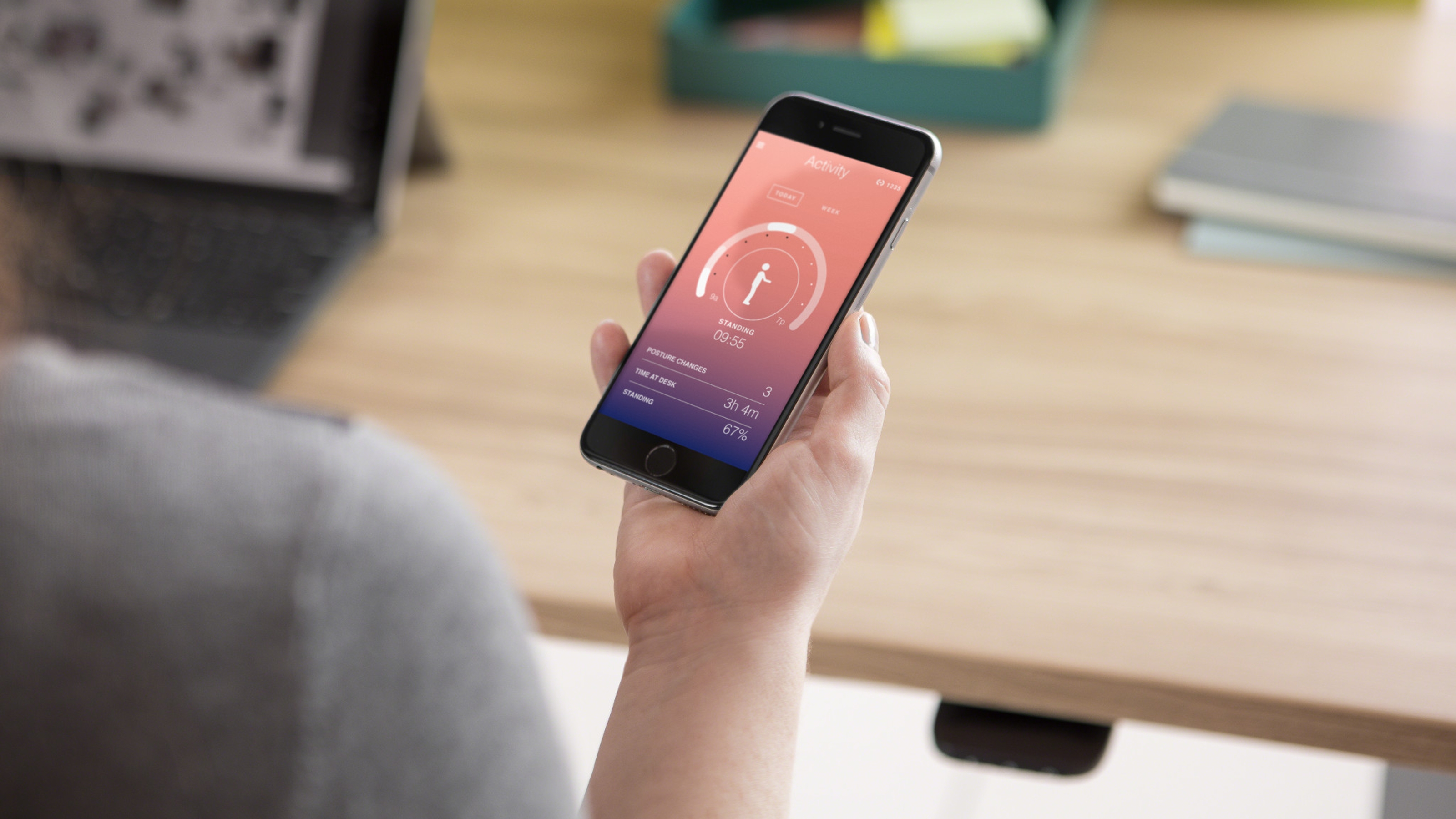 Person holding a mobile phone and looking at the Rise APP