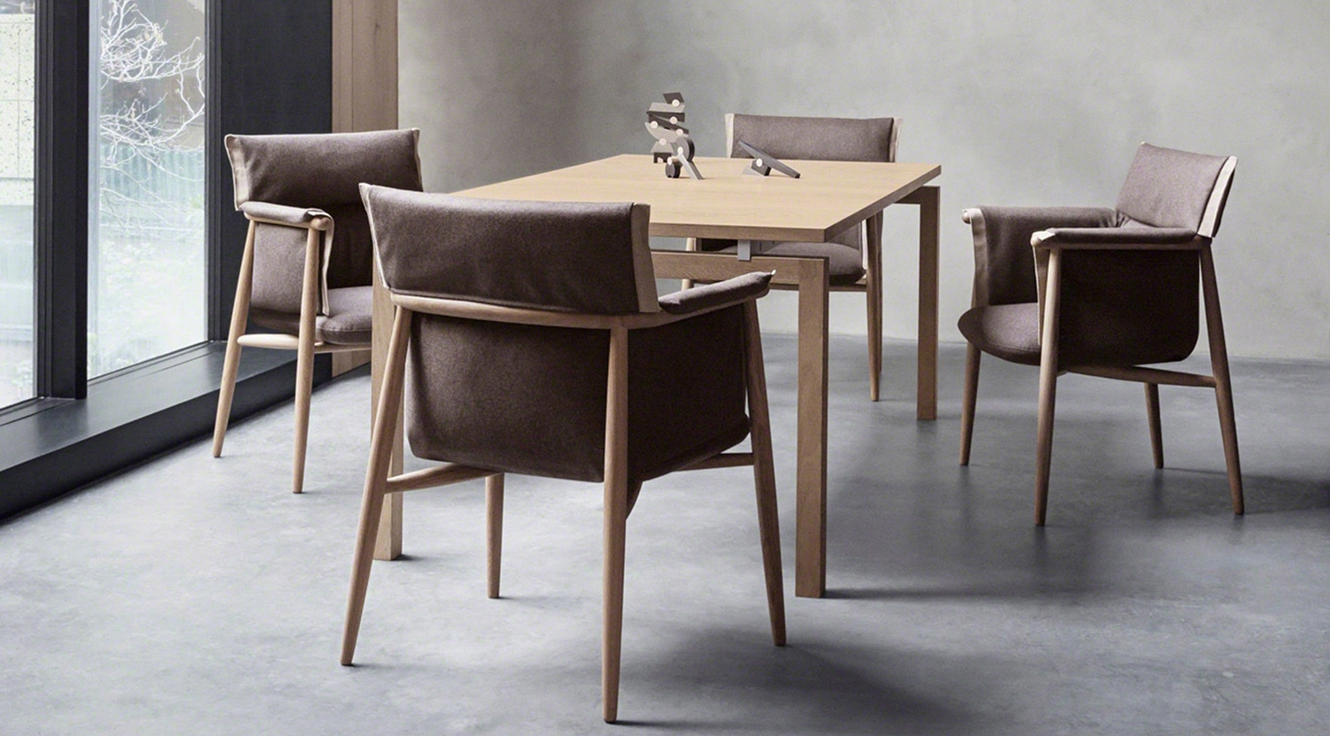 Brown Embrace chairs with cushion and armrests.