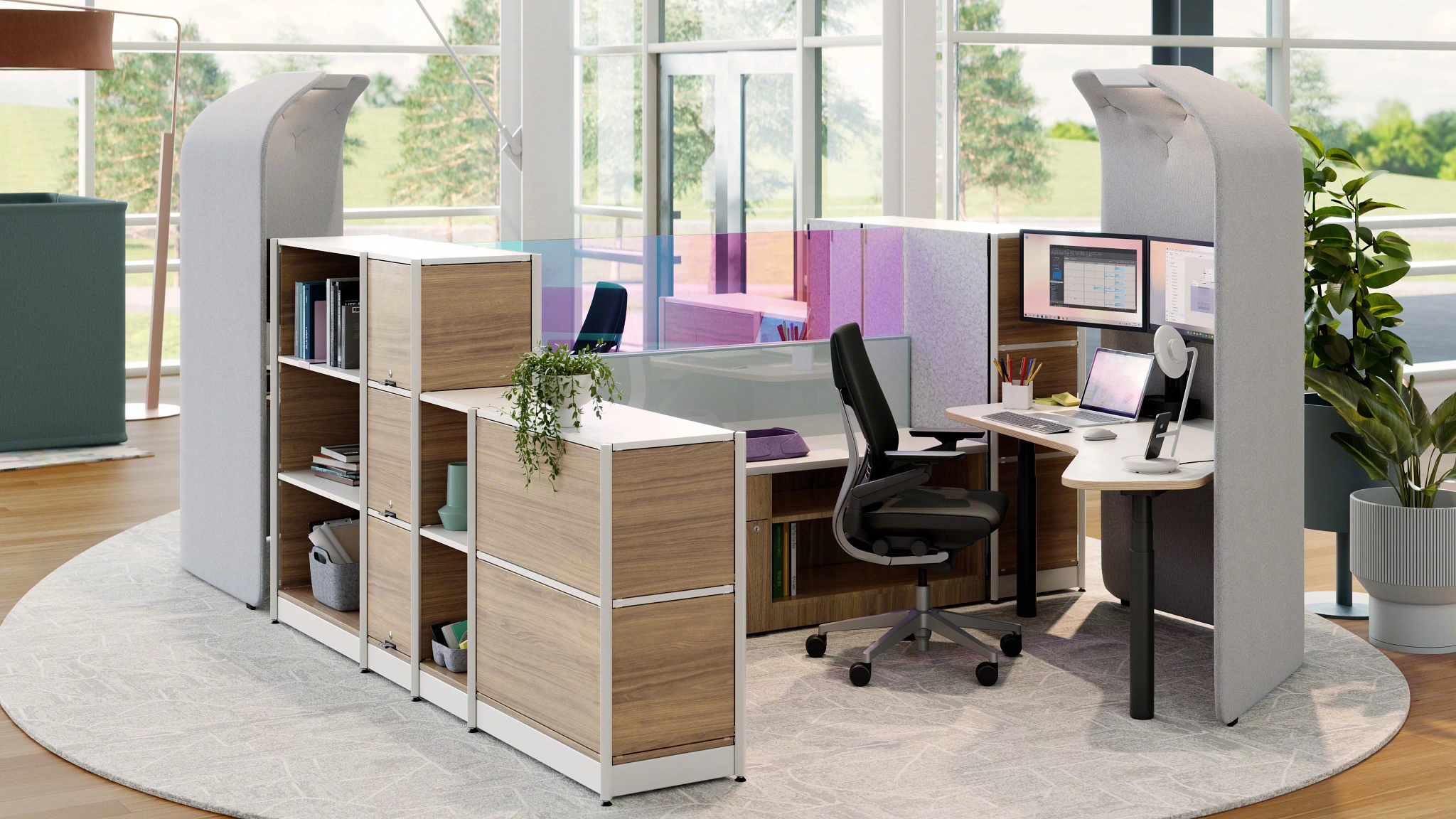Shared workspace zoned with high-panel pods, shelving, and plants instead of walls